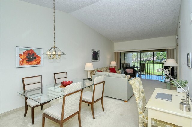 4416 Weybridge Unit 90, Sarasota, FL 34235 - dining area featuring lofted ceiling, carpet, a chandelier, and a textured ceiling