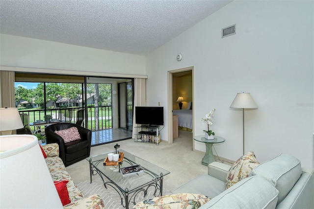 4416 Weybridge Unit 90, Sarasota, FL 34235 - carpeted living area with vaulted ceiling and a textured ceiling