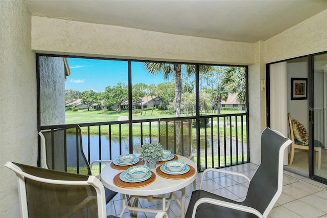 4416 Weybridge Unit 90, Sarasota, FL 34235 - sunroom featuring a water view and healthy amount of natural light