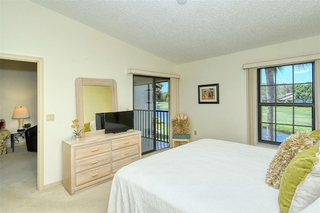 bedroom with light colored carpet, a textured ceiling, vaulted ceiling, and access to outside