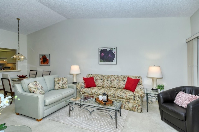 living room with lofted ceiling, a textured ceiling, a notable chandelier, and carpet floors