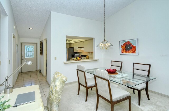 4416 Weybridge Unit 90, Sarasota, FL 34235 - dining space with a chandelier, a textured ceiling, and baseboards