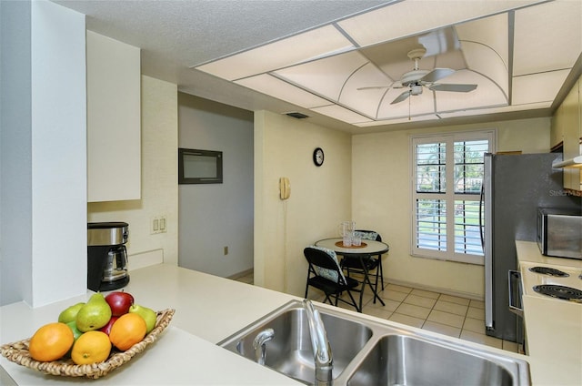 4416 Weybridge Unit 90, Sarasota, FL 34235 - kitchen featuring a ceiling fan, stainless steel microwave, tile patterned floors, and light countertops