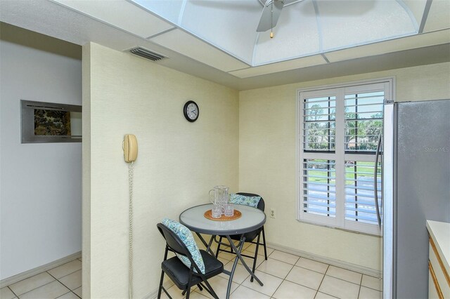4416 Weybridge Unit 90, Sarasota, FL 34235 - dining area featuring light tile patterned floors, a ceiling fan, and baseboards