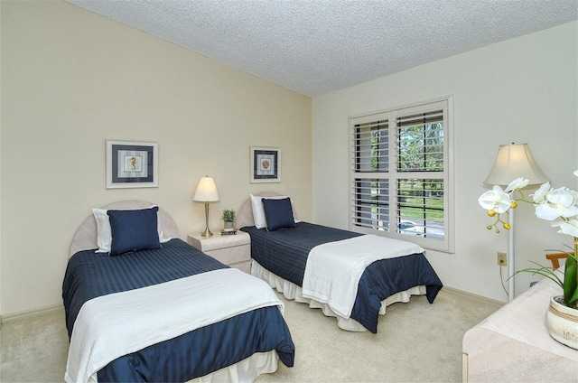 carpeted bedroom featuring a textured ceiling