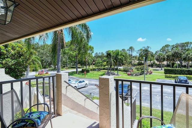 4416 Weybridge Unit 90, Sarasota, FL 34235 - balcony featuring view of wooded area