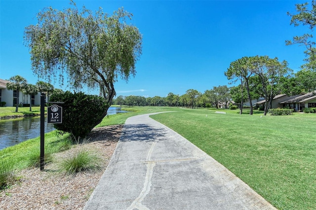 surrounding community featuring a yard and a water view