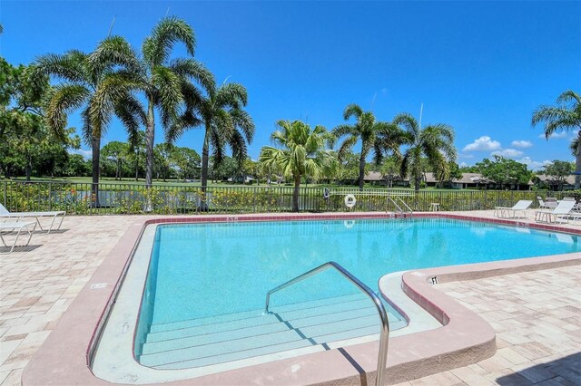 4416 Weybridge Unit 90, Sarasota, FL 34235 - community pool with fence and a patio area