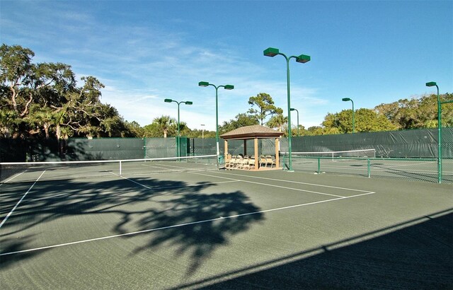 4416 Weybridge Unit 90, Sarasota, FL 34235 - view of tennis court featuring fence and a gazebo