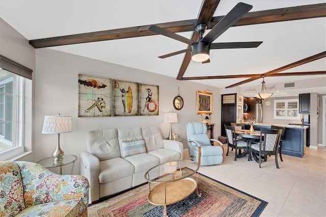 living room with light tile patterned floors, beam ceiling, and ceiling fan