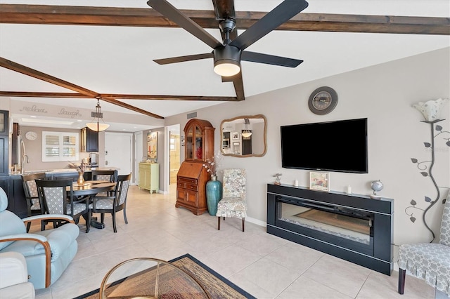 living room with ceiling fan, lofted ceiling with beams, and light tile patterned floors