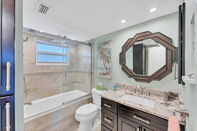 full bathroom with toilet, tile patterned floors, vanity, and shower / bath combination with glass door