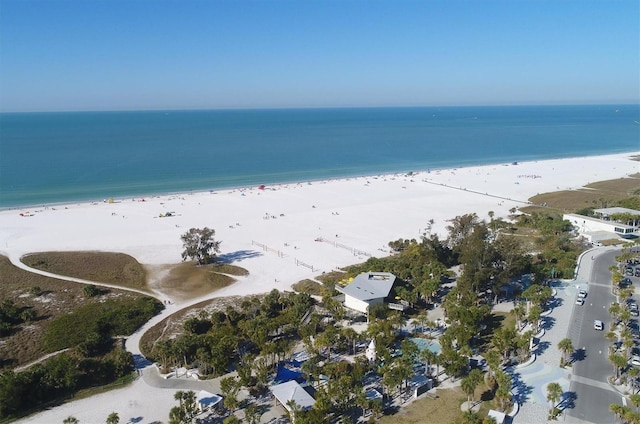 bird's eye view with a water view and a beach view