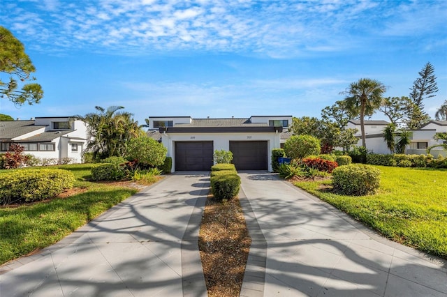 3119 Heatherwood Ln, Sarasota, FL 34235 - modern home with driveway, stucco siding, and a front lawn