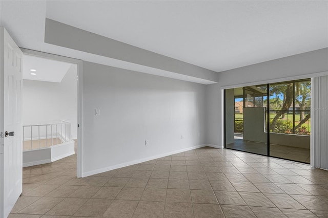 3119 Heatherwood Ln, Sarasota, FL 34235 - tiled empty room featuring baseboards