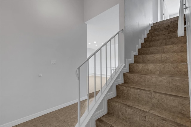 stairway featuring tile patterned floors