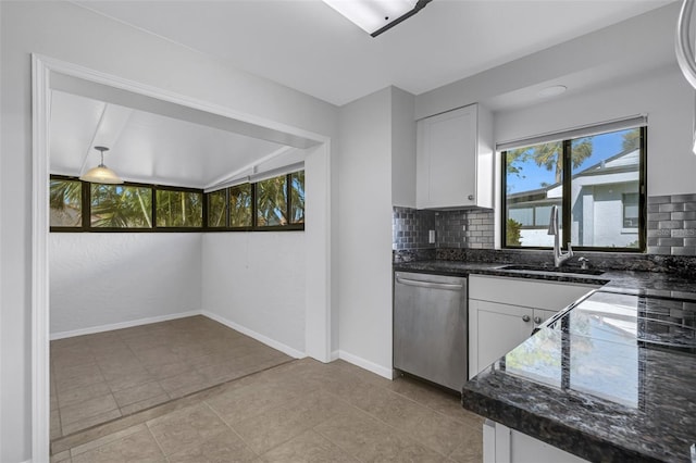 kitchen featuring sink, lofted ceiling with beams, white cabinetry, stainless steel dishwasher, and decorative backsplash