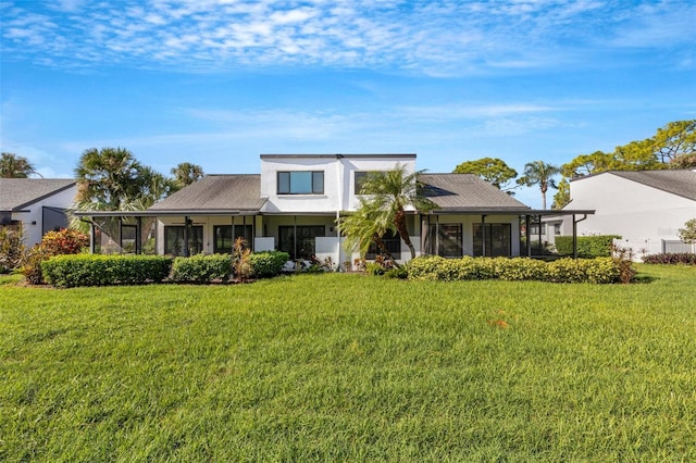 3119 Heatherwood Ln, Sarasota, FL 34235 - view of front facade featuring a sunroom, a front yard, and stucco siding