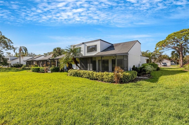 3119 Heatherwood Ln, Sarasota, FL 34235 - view of side of property with a sunroom and a yard