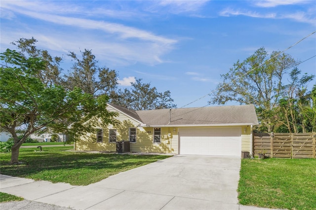 ranch-style home with central AC unit, a garage, and a front yard