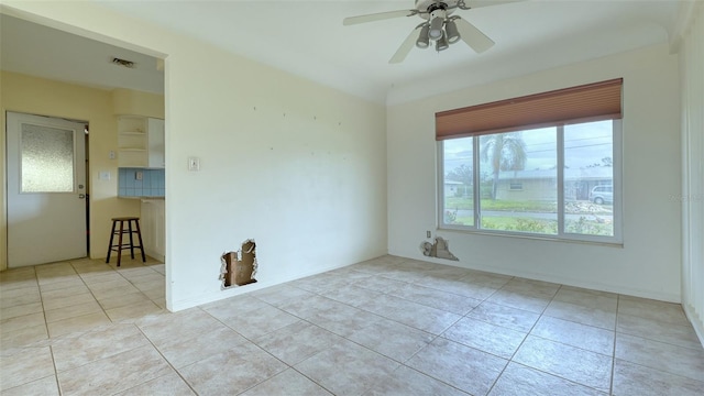 tiled empty room with ceiling fan