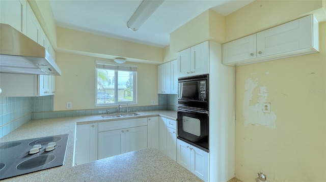 kitchen featuring black appliances, sink, decorative backsplash, and white cabinets