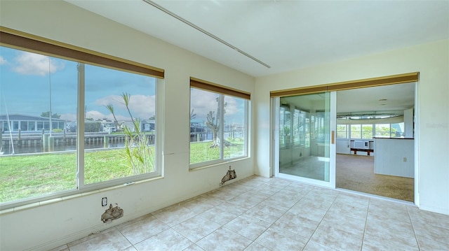 unfurnished sunroom with a water view