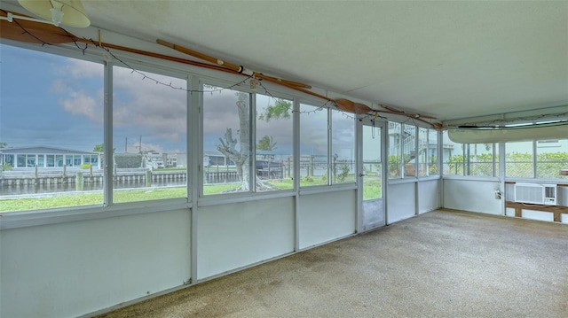 unfurnished sunroom with plenty of natural light, a water view, and cooling unit