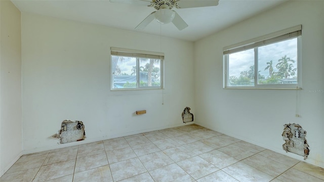 unfurnished room with light tile patterned floors and ceiling fan