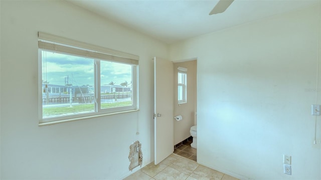 unfurnished room featuring ceiling fan and light tile patterned flooring