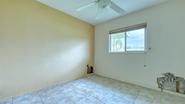 tiled empty room featuring ceiling fan