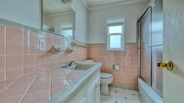 full bathroom with vanity, tile walls, shower / bath combination with glass door, and ornamental molding