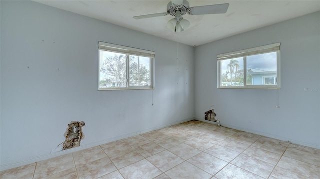 tiled spare room with ceiling fan