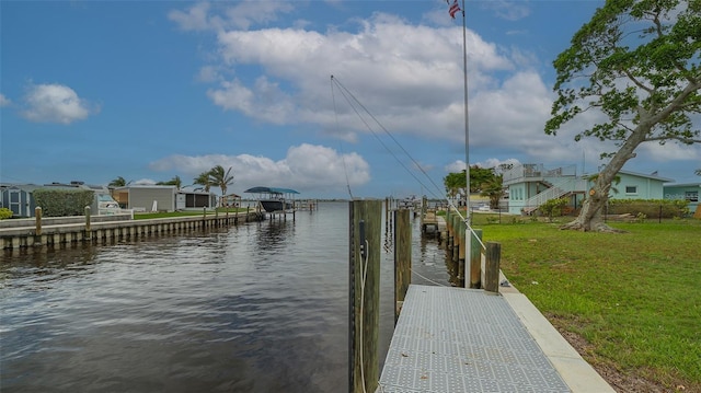 view of dock featuring a lawn and a water view