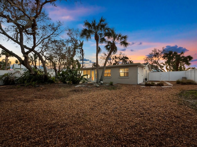 view of back house at dusk