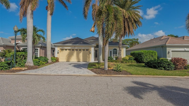 view of front of home with a garage and a front yard