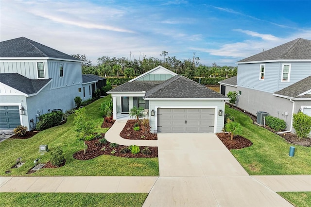 view of front of home featuring a garage, central air condition unit, and a front lawn