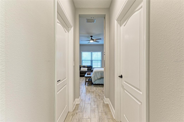 hallway featuring light wood-type flooring