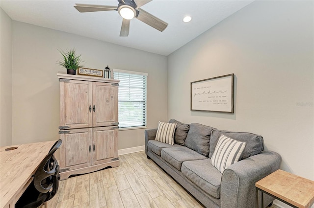 living room with light hardwood / wood-style floors and ceiling fan