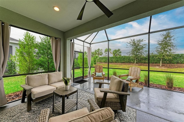 sunroom featuring ceiling fan and plenty of natural light