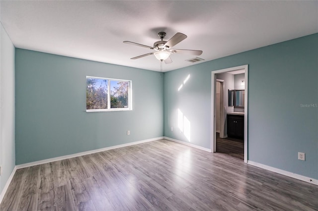 unfurnished room featuring hardwood / wood-style floors and ceiling fan