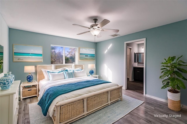 bedroom featuring dark wood-type flooring, connected bathroom, and ceiling fan