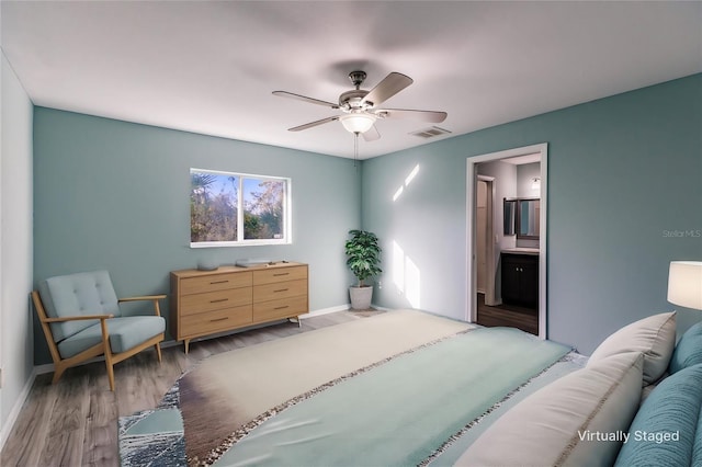 bedroom featuring wood-type flooring, connected bathroom, and ceiling fan