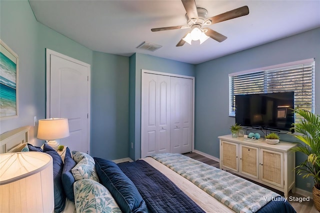 bedroom with hardwood / wood-style floors, a closet, and ceiling fan