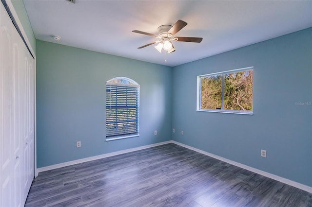 empty room featuring ceiling fan and dark hardwood / wood-style floors