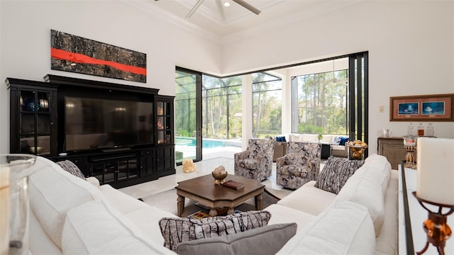 living room with ornamental molding, a towering ceiling, coffered ceiling, beamed ceiling, and ceiling fan