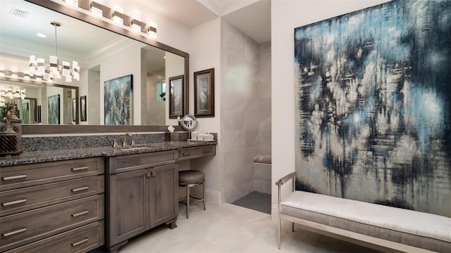 bathroom with vanity, an inviting chandelier, and crown molding