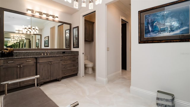 9260 Swaying Branch Rd, Sarasota, FL 34241 - full bath with a chandelier, toilet, vanity, and baseboards
