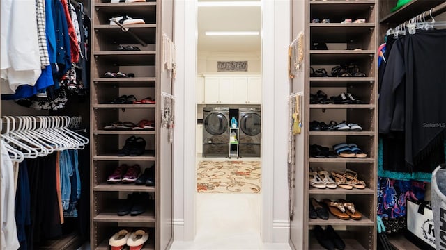 walk in closet with washing machine and clothes dryer