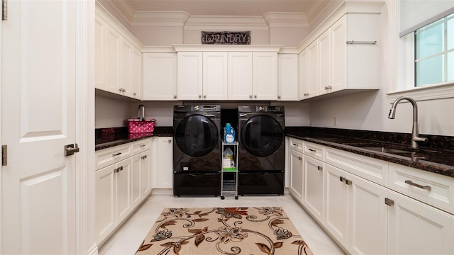 laundry area with cabinets, sink, ornamental molding, light tile patterned floors, and independent washer and dryer